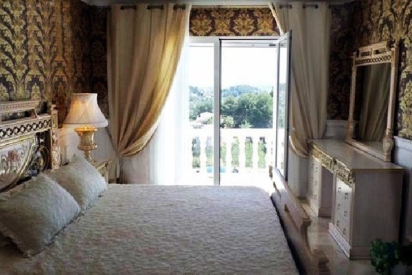 One of the luxurious bedrooms with beautiful details and direct access to the terrace