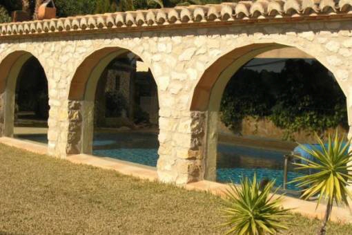 Pool behind elegant stone arcs